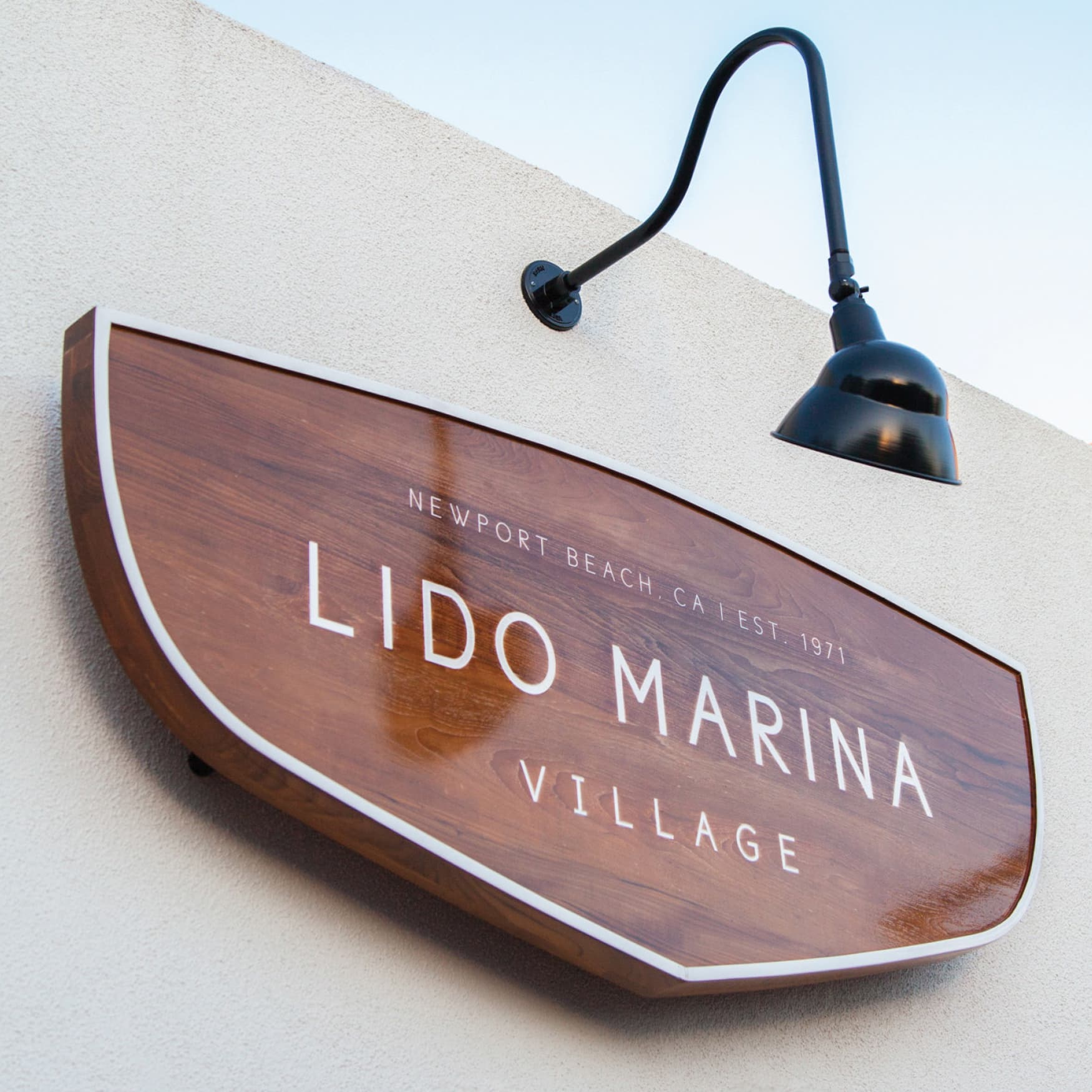 Close up image of the wooden nautical signage for Lido Marina Village in Newport Beach, California designed by RSM Design for the retail village. 