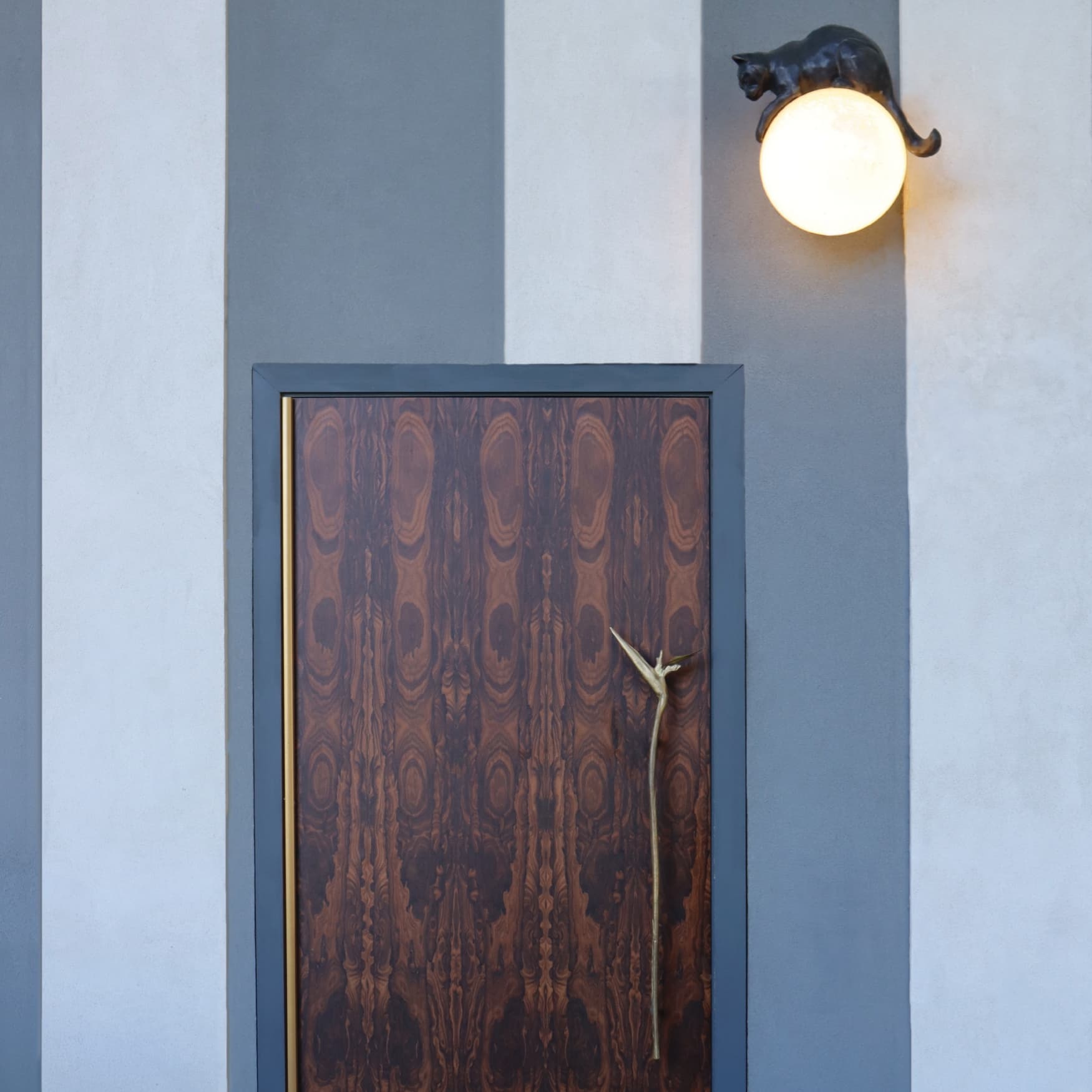 Image of the door and custom light designed by RSM Design for the speakeasy at the Hotel Swexan in Dallas, Texas. Entrance to Babou's, the speakeasy bar at the Hotel Swexan. 