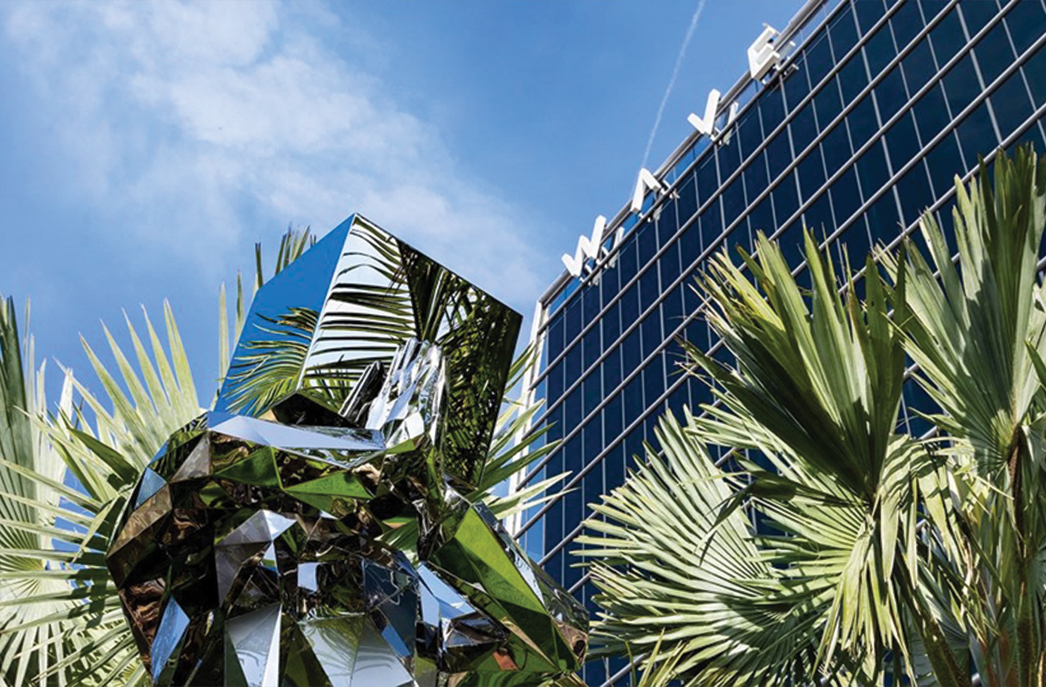 Angled view of the rooftop signage for the Wave Hotel in Orlando, Florida designed by RSM Design. Mirrored sculpture within the planter at the Wave Hotel.l