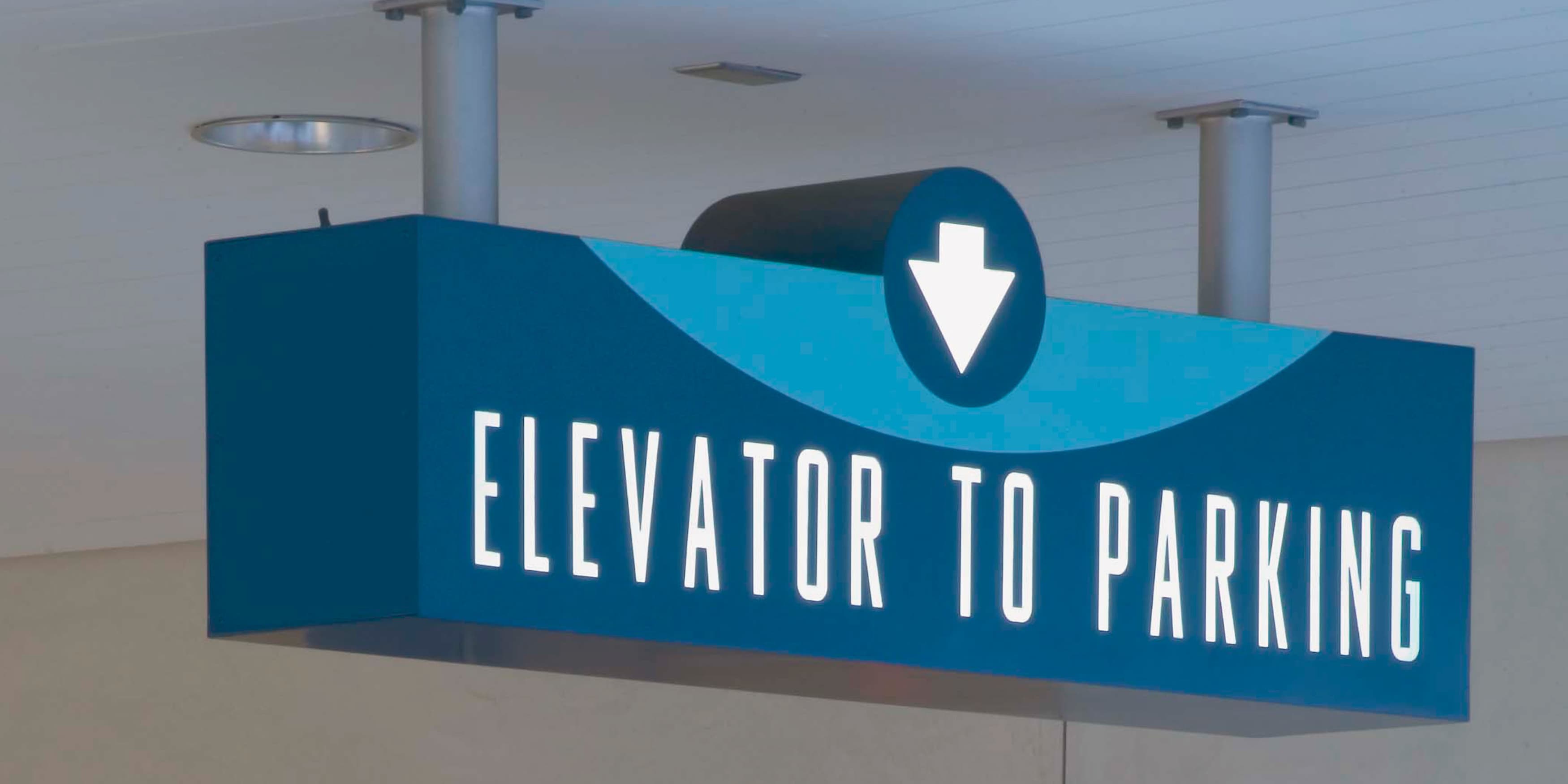 Tone on tone blue signage for the elevator and parking at City of Beverly Hills designed by RSM Design. 