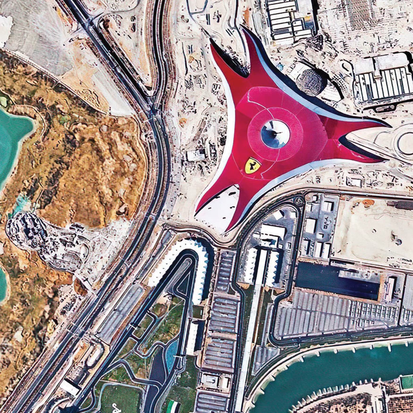Aerial view of Ferrari World on Yas Island in Abu Dhabi. The red roof can be seen for miles with a race track attached to the building.