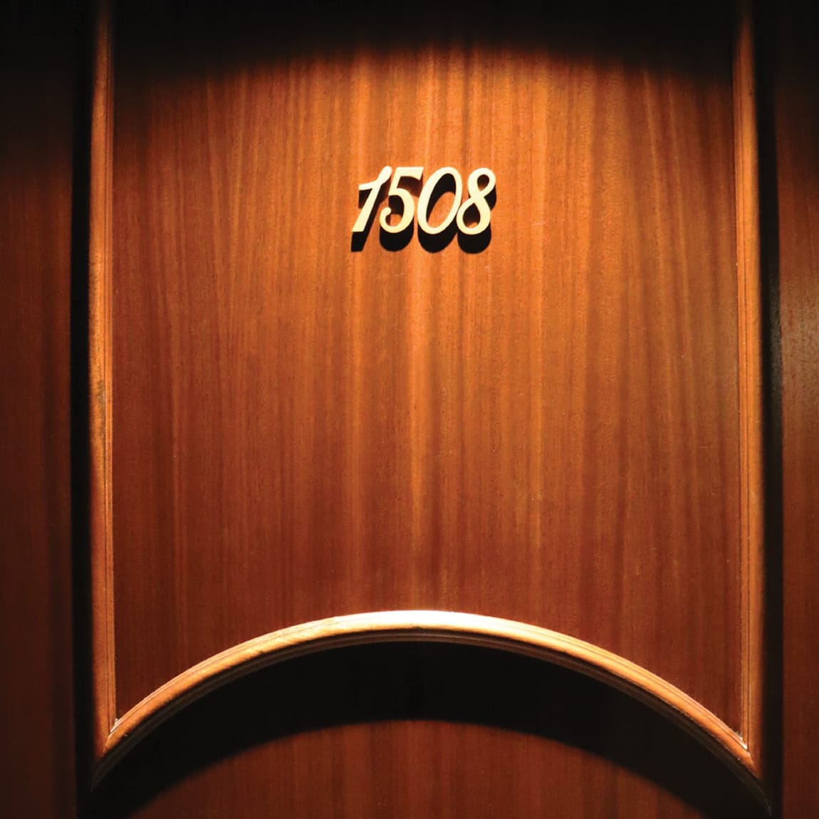 Gold script room number "1508" on a wood-paneled door at The Swexan Hotel - environmental graphic design by RSM Design
