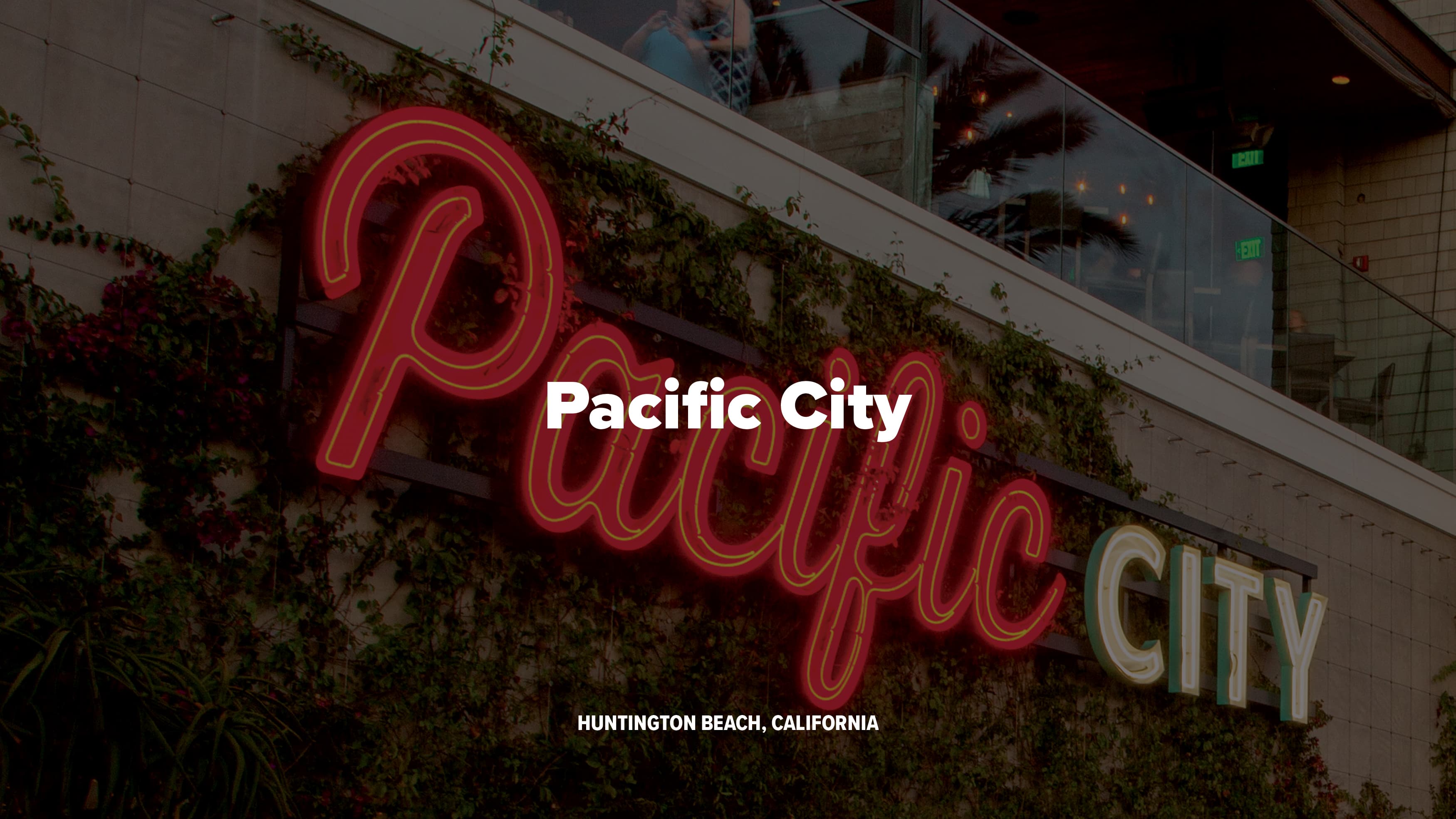 Pacific City branded open-face channel letters mounted to a landscaping wall