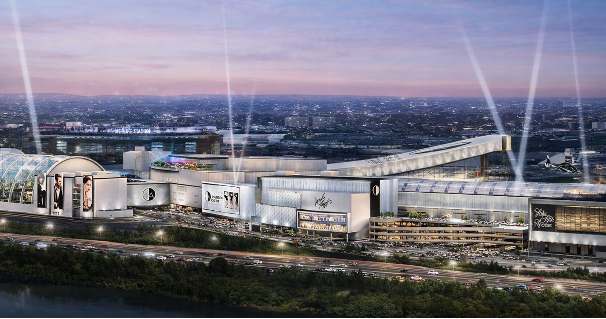 Dusk aerial architectural rendering of American Dream mall in East Rutherford, New Jersey, showcasing the full-scale exterior with large-format building signage, digital LED displays, fashion campaign graphics, the American Dream logo mark, and Saks Fifth Avenue anchor tenant signage along the facade — with MetLife Stadium visible in the background — illustrating RSM Design's master sign program, environmental graphic design, and branded environments for a large-scale mixed-use retail and entertainment destination adjacent to a sports and entertainment complex.