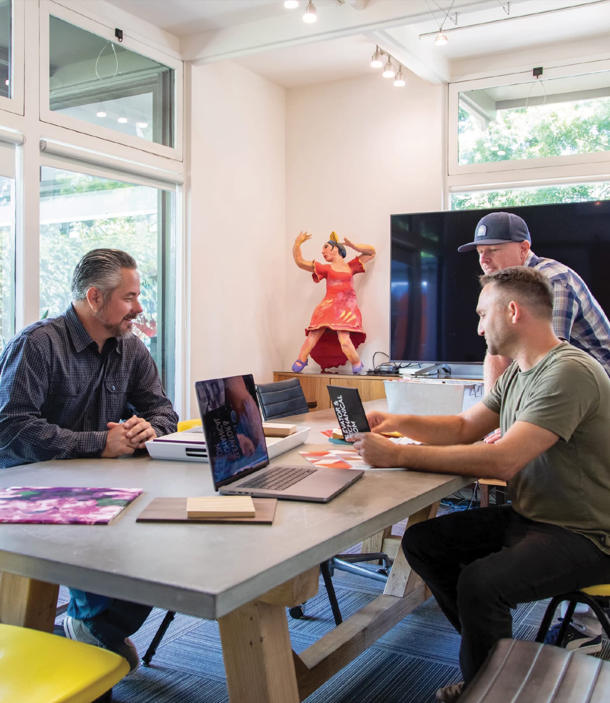 Team members at RSM Design planning and reviewing designs around a conference table