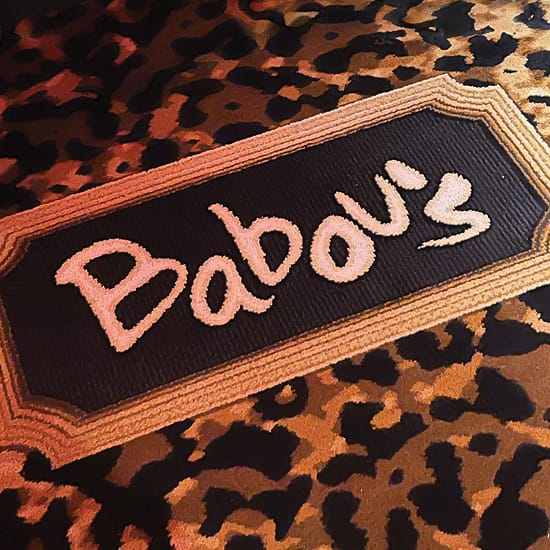 Woven "Babou's" logo patch on a leopard-print textile at The Swexan Hotel - environmental graphic design by RSM Design
