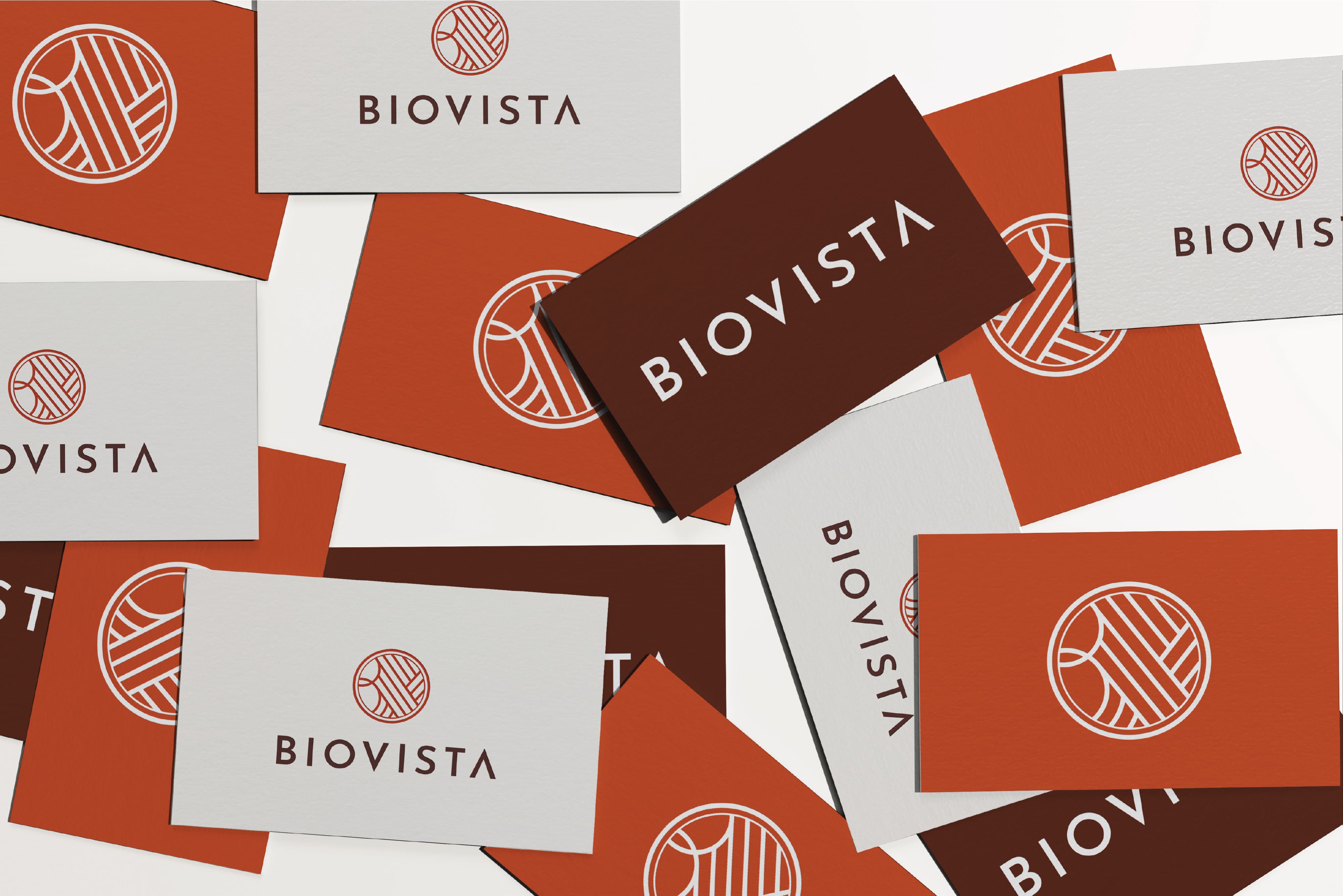 Scattered collection of business cards in white, orange, and dark brown, each displaying the Biovista logo mark and wordmark in varying color combinations.