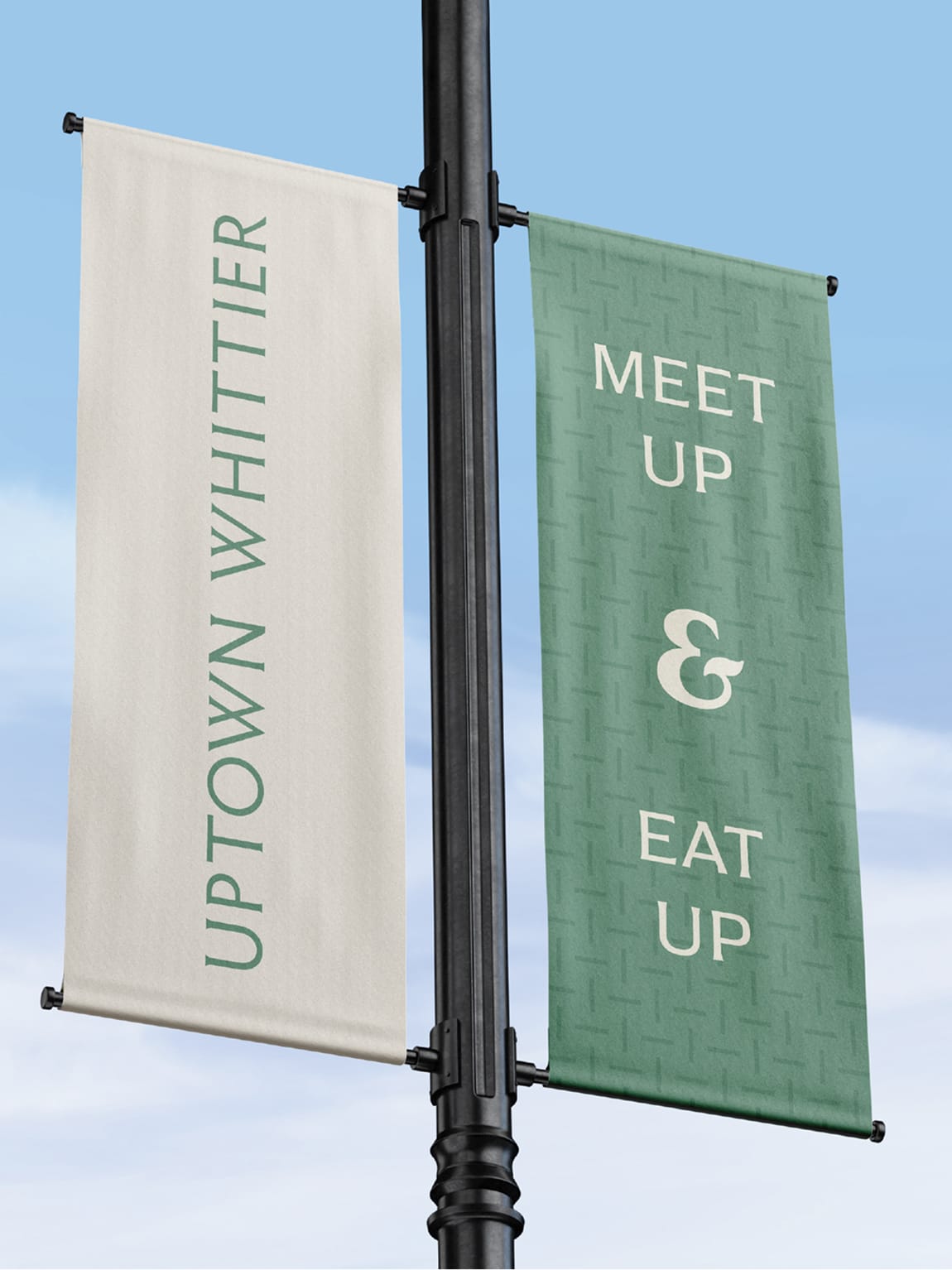 Uptown Whittier street banners featuring clean typography and a soft green palette, reinforcing the district identity and activating the public streetscape.