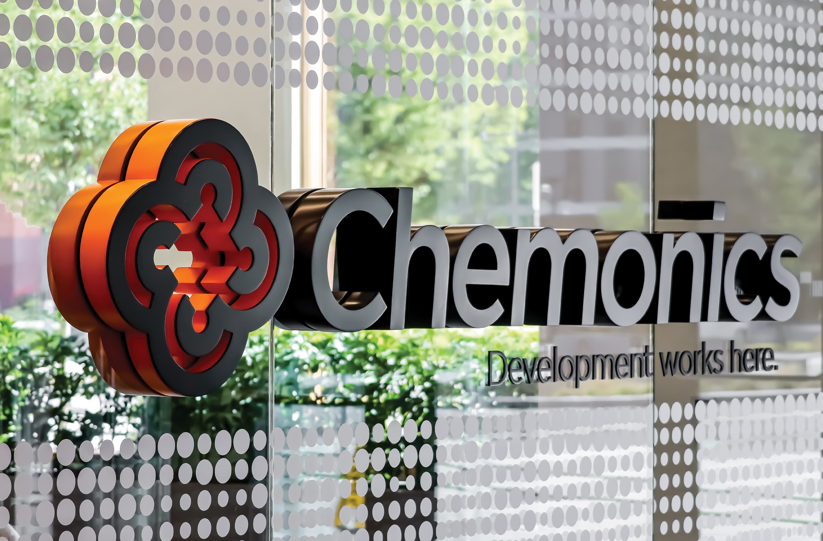 Chemonics International logo signage on glass wall by RSM Design. 