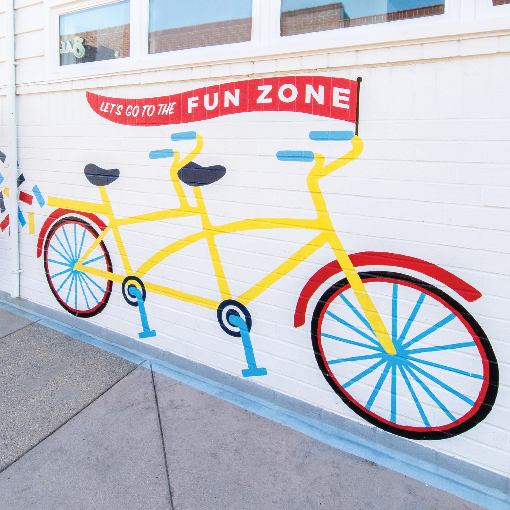 "Let's go to the Fun Zone" painted colorful bike graphic with confetti for the Balboa Fun Zone in Newport Beach, California.