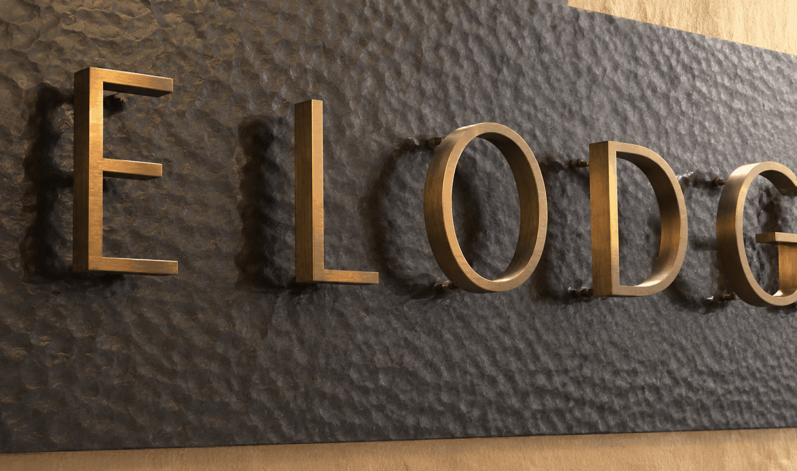 Close-up of glossy gold dimensional letters mounted on a textured dark stone wall, photographed at an angle with a warped, distorted rendering effect making the text difficult to read.